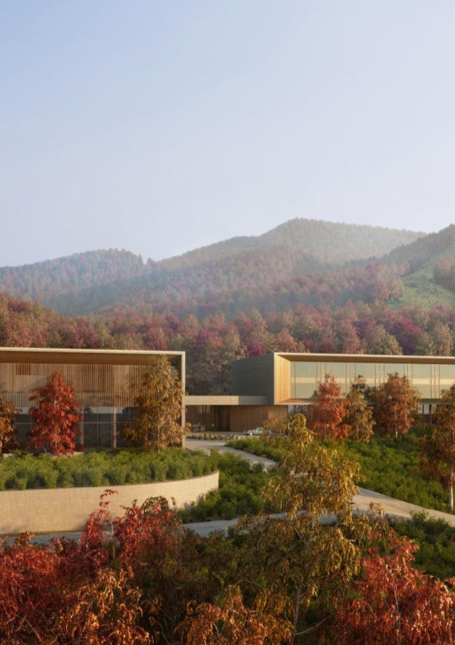 A wellness retreat property, low buildings nested in autumn forest